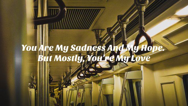 empty train car bathed in warm light with a loving poem written across it
